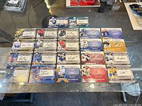 All 22 autographed CHL hockey cards laid out in four rows on glass table