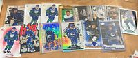 Full lot of 14 Quinn Hughes Upper Deck cards laid out