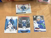 All four Thatcher Demko Upper Deck cards laid out