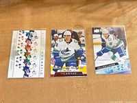 Group shot of all three Nils Hoglander Upper Deck rookie cards in top loaders