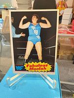 Front view of WWF Fabulous Moolah card on stand