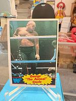 Front view of trading card on stand showing wrestler image and card graphics