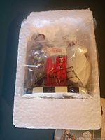 Sealed figurine in styrofoam and plastic wrap