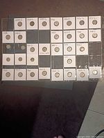 Full view of the plastic page showing 26 dime-filled flips and four empty pockets
