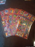 Group view of multiple binder pages showing Marvel X-Men trading cards with gold foil coins