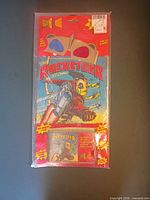 Full sealed package showing comic cover, glasses and cassette