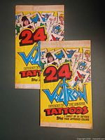 Front view of two sealed Topps Voltron tattoo packs