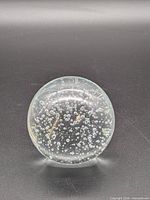 Front view of clear glass sphere showing internal bubble pattern
