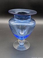Full view of blue glass pedestal vase showing shape and color