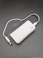 Top view of Blue Hive power bank with attached USB cable