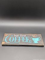 Full view of wooden sign front showing text and graphic