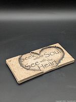 Front of plaque showing full inscription and heart motif