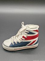 Left side view of ceramic sneaker piggy bank showing Union Jack design and sole detail