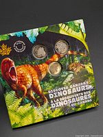 Front of display card showing three dinosaur 25-cent coins