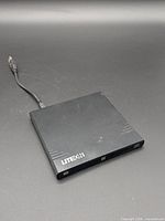 Top view of slim Lite-On external optical drive with attached USB cable