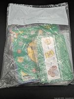Front view of sealed "Learn About Money" kit in plastic bag