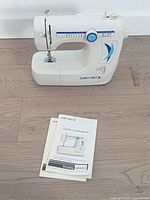 Front angled view of Euro-Pro X sewing machine with manuals