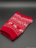 Folded red and white dog sweater full view