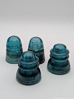Group shot of all four blue glass Hemingray insulators