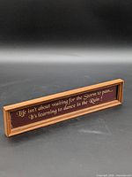 Front view of framed sign with quote
