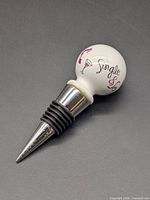 Full view of wine stopper on dark background