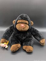 Full view of plush gorilla holding banana