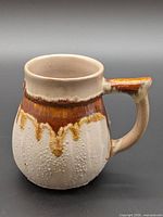 Front profile of ceramic mug showing glaze colors and texture