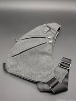 Full view of grey waist bag showing shape, strap and pockets