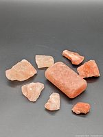 All eight Himalayan salt pieces on black background