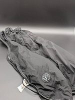 Full view of black Hunter dog coat laid flat showing overall design