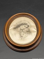 Full view of oval wood frame with mother and child artwork