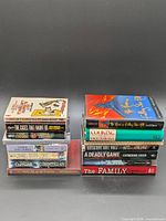 Two vertical stacks of assorted books showing spines and covers