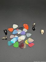 Group shot of all flat picks and finger/thumb picks