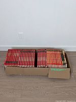 Box of red Popular Mechanics hardcovers, two rows