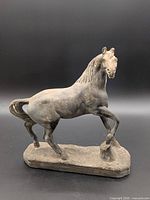 Full view of horse statue on base