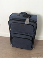 Front view of navy London Fog suitcase