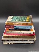 Stack of eight assorted music books showing all spines