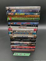 Full stack of approximately 18 DVDs with visible spines