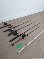 All six rods laid out with measuring tape for scale