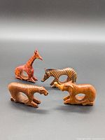Group shot of four wooden safari animal napkin rings