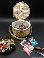Whole lot showing basket, bowl of thread, carded notions