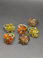 Six glass flower napkin rings, overhead view