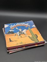 Stack of vinyl records showing Glen Campbell album on top
