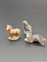 Group view of three Wade animal figurines: zebra, dog, big cat