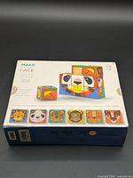 Front of box showing product name, animal face examples, and cube illustration