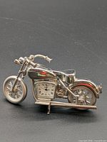 Full view of silver-tone motorcycle figurine with clock in engine area