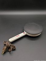 Full view of Multichef crepe maker showing handle, cooking surface, and cord