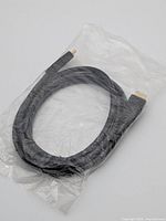 Sealed black HDMI cable in plastic packaging