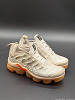Angled front and side view of both shoes displaying overall style and condition