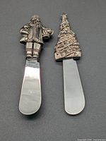 Front view of both butter spreaders showing decorative handles and blades